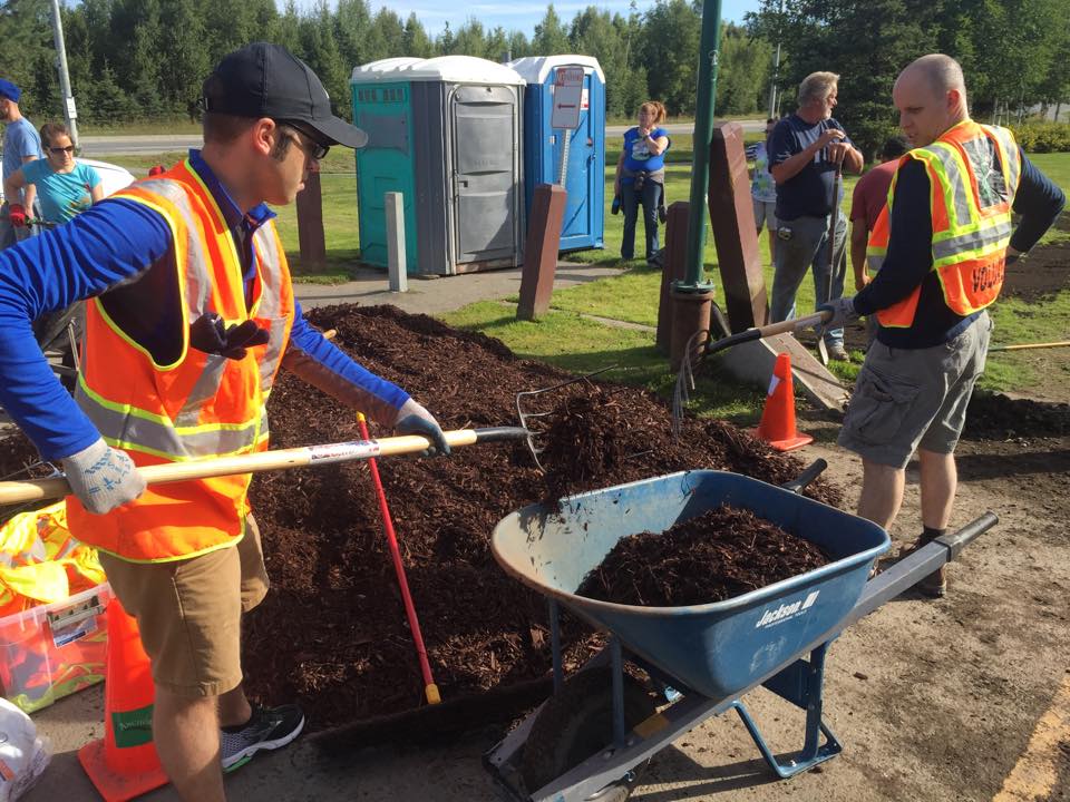 Volunteers shoveling soil