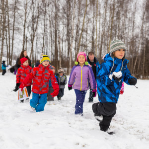 Children run through the snow