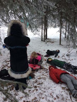 Kids laying down in the snow outside