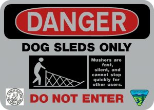 Sign that reads: "Danger. Dog Sleds Only. Mushers are fast, silent, and cannot stop quickly for other users. Do Not Enter."